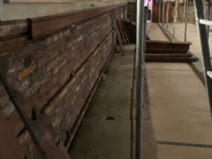 Photo showing that the wainscoting in the main worship & performance space at The Link Centre has been removed for refurbishing