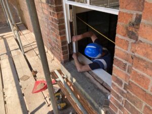 Photo showing repair work underway on window frames
